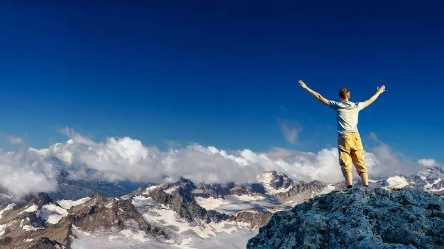 man with hands in air